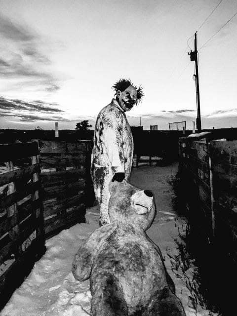 Dark Acres clown performer with a teddy bear